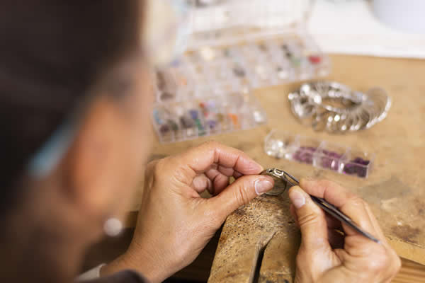 jeweler-hands-putting-jewel-ring